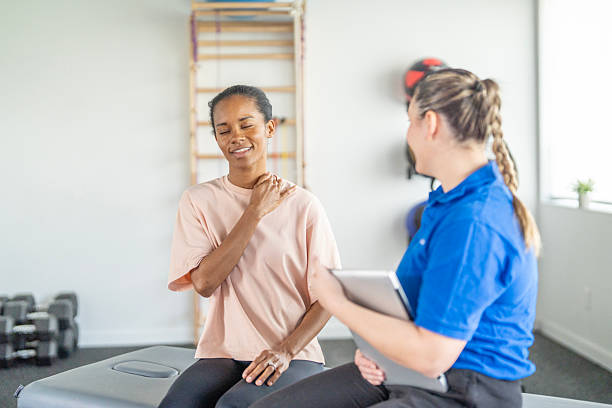 istock Therapy Session With Female Client And Therapist In Gym Rehabilitation Setting 2246610607