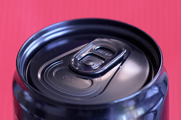 A detailed look at a beverage can lid with a shiny pull tab, emphasizing its modern features and finish.