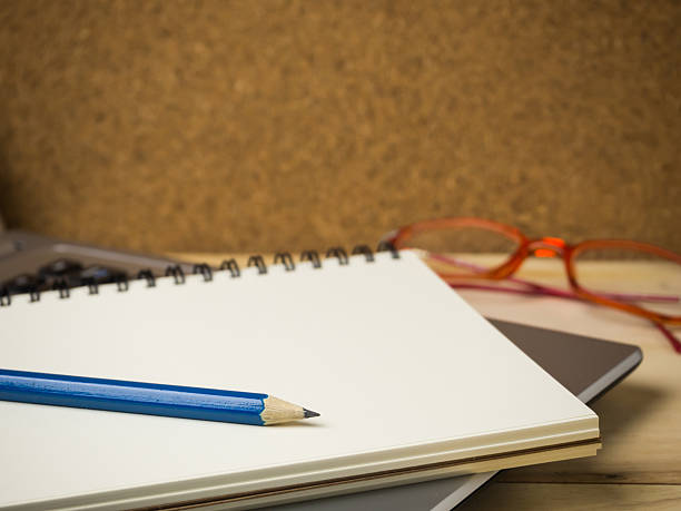 istock Pencil and notebook on laptop for business concept. 2246612898