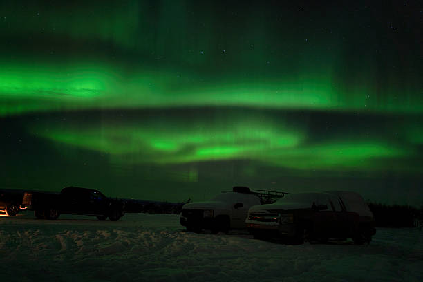 Immerse yourself in the breathtaking magic of Alaska’s winter nights with this striking photograph of the Northern Lights dancing above snow-covered trucks in Fairbanks. Vivid green ribbons ripple across the star-filled sky, illuminating the frozen landscape with an otherworldly glow. This image captures the raw, untouched beauty of the Arctic—silent, powerful, and awe-inspiring. Perfect for anyone who dreams of adventure, craves the serenity of remote wilderness, or simply wants a stunning statement piece that brings the wonder of the aurora borealis into their home or office.