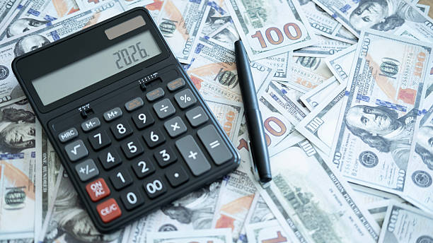 istock A calculator displaying “2026” surrounded by US dollar notes and a pen, representing budgeting, money management, and future financial strategy. 2246617731