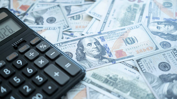 istock A calculator placed on hundred-dollar bills, representing wealth management, cash flow tracking, and financial preparation. 2246617734