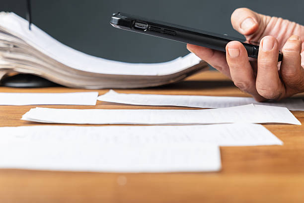 istock Person using smart phone to photograph and scan receipts 2246617761