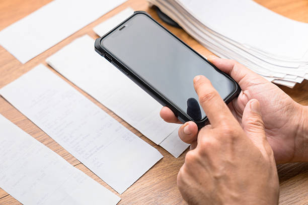 istock Person using smart phone to photograph and scan receipts 2246617768