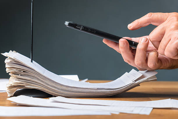 istock Person using smart phone to photograph and scan receipts 2246617778