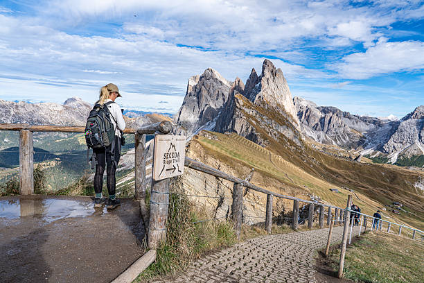 Tourists are enjoying the view of Seceda mountains in the Dolomites, South Tyrol, Italy.
