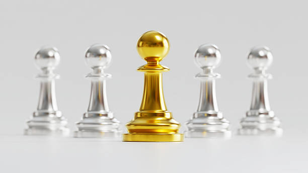 istock Golden Chess Pawn Standing Distinctly Among Silver Counterparts on Light Background 2246619496