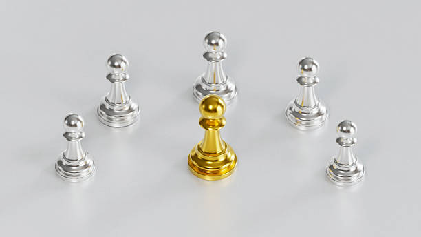 istock Golden Chess Pawn Standing Centrally with Leadership Amid Silver Pawns on Light Background 2246619530