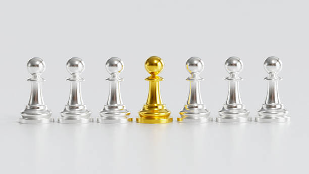 istock Golden Chess Pawn Standing Centrally with Leadership Amid Silver Pawns on Light Background 2246619534
