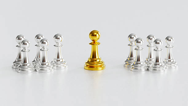 istock Golden Chess Pawn Standing Distinctly Among Silver Counterparts on Light Background 2246619549