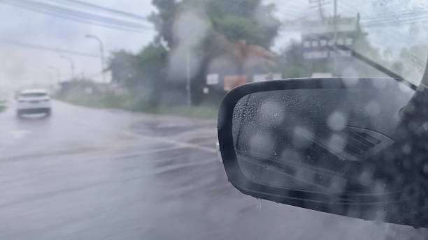 istock Raindrops on a car mirror reflect a softly blurred street scene, capturing the quiet essence of a rainy day. 2246620822