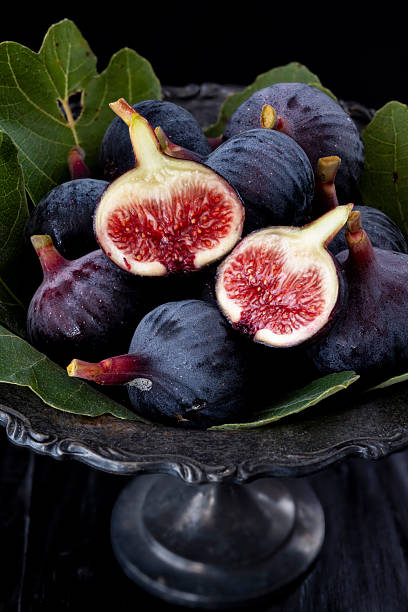 Fresh Ripe Figs In Dark Bowl With Leaves