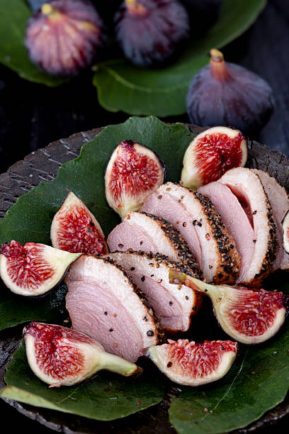 Pan-fried duck breast cooked in a skillet with fresh thyme.