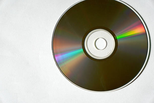 Close-up of a CD showing vibrant multicolor reflections from its reflective surface.