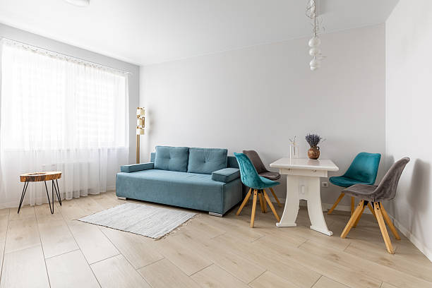 istock Bright Minimalist Living Room with Blue Sofa and Dining Table 2246631215