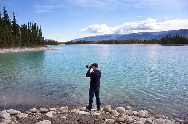 Canada Yukon, Watson lake, man taking photograph