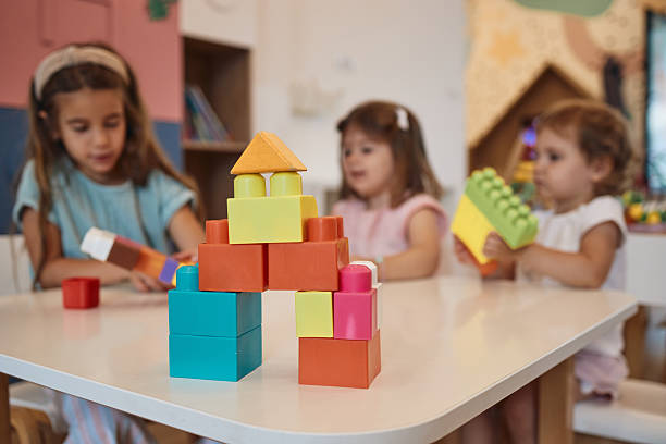 istock Beautiful children playing with toy blocks in kindergarten 2246633019