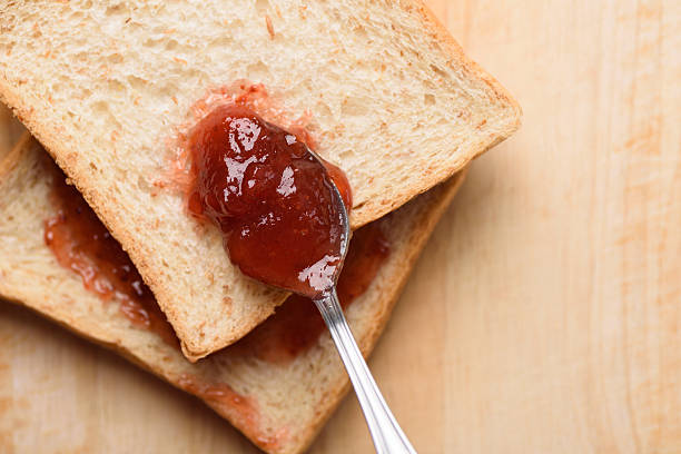 Strawberry jam for a classic breakfast on wooden background