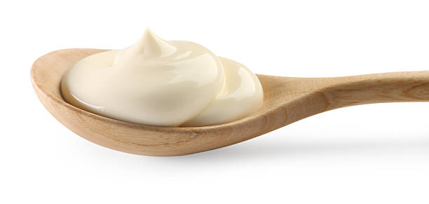 istock Natural yogurt in wooden spoon isolated on white 2246638246