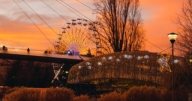 istock Ferris wheel and bridge with christmas lights at sunset 2246639246