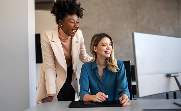 istock Happymultiethnic businesspeople laughing while collaborating on a new project in an office. 2246639328