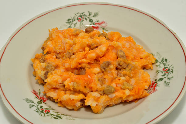 Pumpkin, raisin and rice porridge lies on a plate.