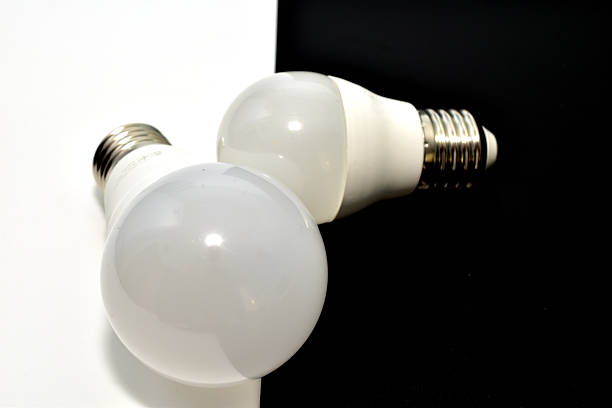 LED lamps with E27 base, but of different power, on a black and white background.