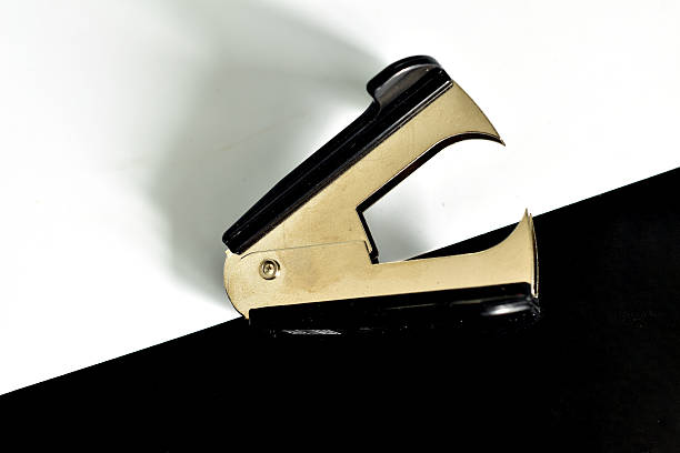 Black office stapler and Staple Remover isolated on a white background.