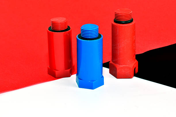 Hot and cold water pipe plugs against a background of three shades.