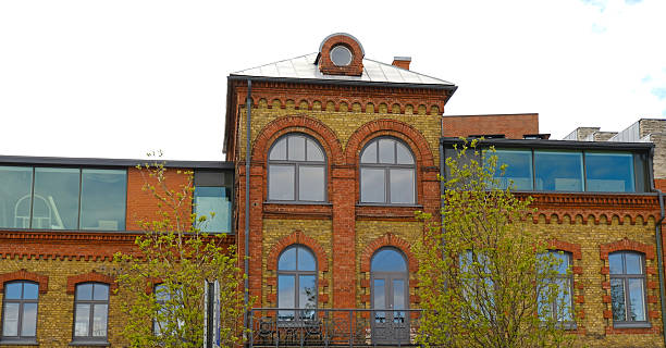 istock Renovated historic brick building with arched windows and modern glass extensions. A blend of classic and contemporary urban architecture. Real estate, and property marketing. 2246643136
