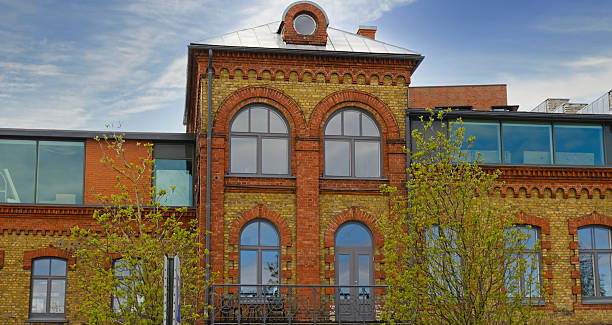 istock Renovated historic brick building with arched windows and modern glass extensions. A blend of classic and contemporary urban architecture. Real estate, and property marketing. 2246643216