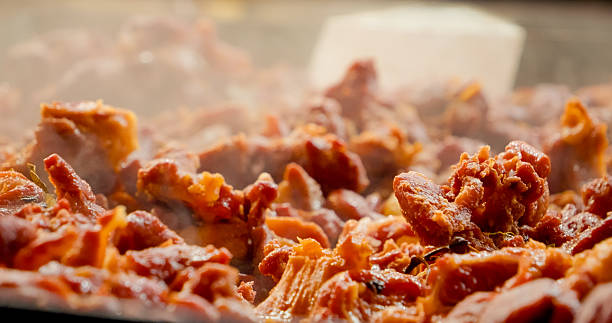 Cooking fatty pork meat in a large pan
