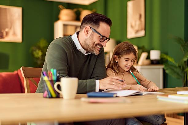 istock Dad Helps His Daughter With Homework At A Cozy Green Home Table 2246646356
