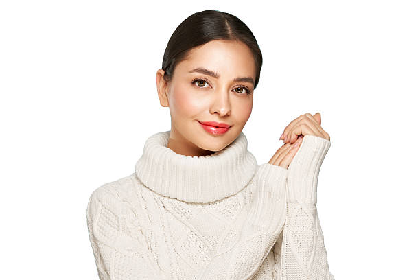 istock Young beautiful woman in a warm  white sweater 2246647560