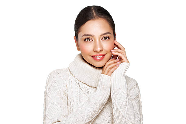 istock Young beautiful woman in a warm  white sweater 2246647584