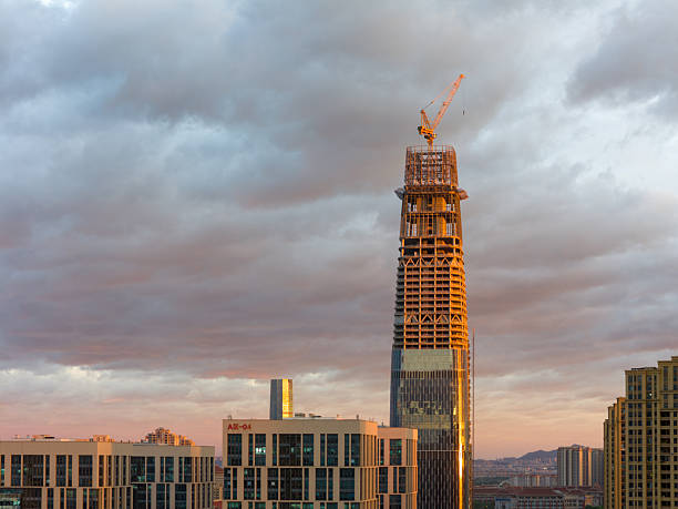 istock A Skyscraper Under Construction Dominating the Urban Skyline Against a Dramatic Cloudy Sunset 2246647882