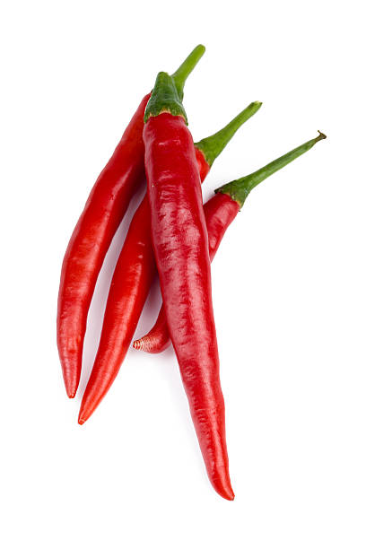 istock Bright red chili peppers arranged on a white background 2246648011