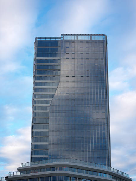 istock Modern High-Rise Building with Glass Facade Against a Blue Sky 2246648163
