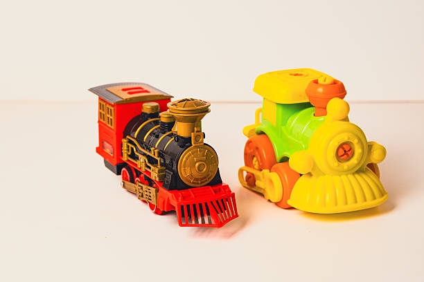 Brightly colored toy trains standing together on a white surface, ready for imaginative playtime adventures.