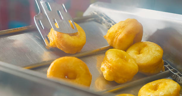 istock Automated production of ring doughnuts on a conveyor belt 2246648740