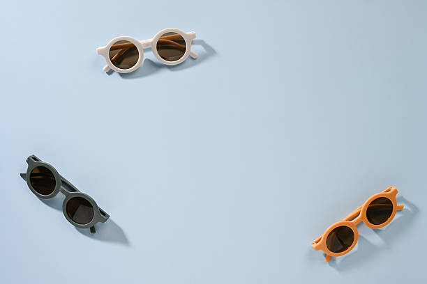 istock Stylish sunglasses collection on pastel blue surface 2246649147