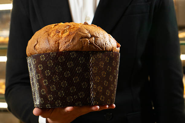istock Elegant man holding an artisanal panettone 2246651132