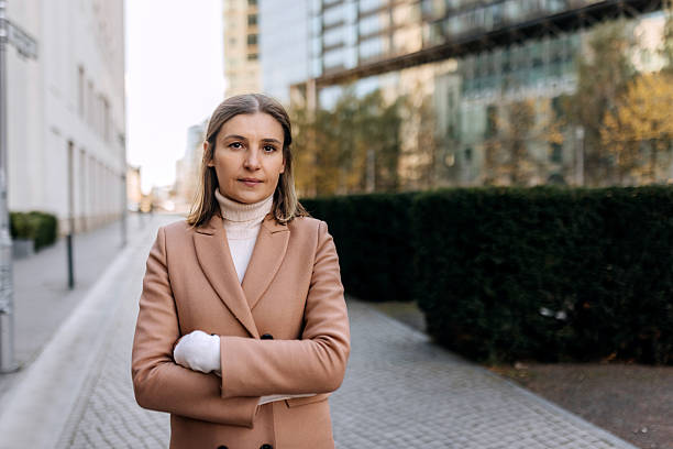 istock Well dressed mature woman standing and posing for camera 2246651176