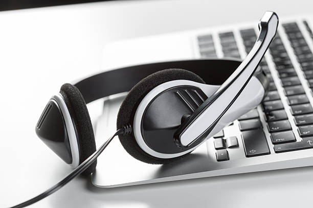 istock Headset placed next to a laptop keyboard on a desk in a quiet workspace 2246651595