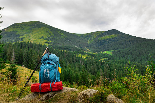 Summer hiking in the mountains with a backpack and a tent. Beautiful mountain landscape.