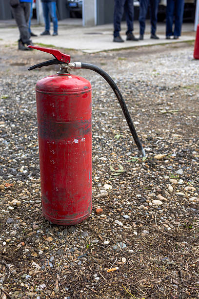 istock Old red fire extinguisher on gravel ground during a firefighting training. 2246654805