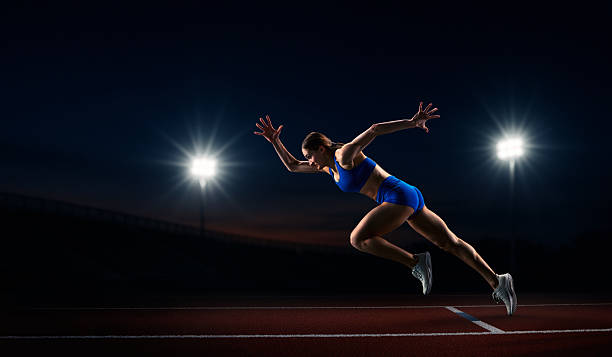 istock Handmade collage. Female athlete sprinting from starting blocks on illuminated track 2246656903