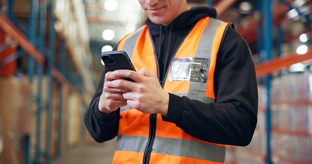 istock Hands, mobile and man in warehouse for logistics, distribution schedule or inventory management. Phone, shipping worker and app to check stock, online communication and email for supply chain 2246657495