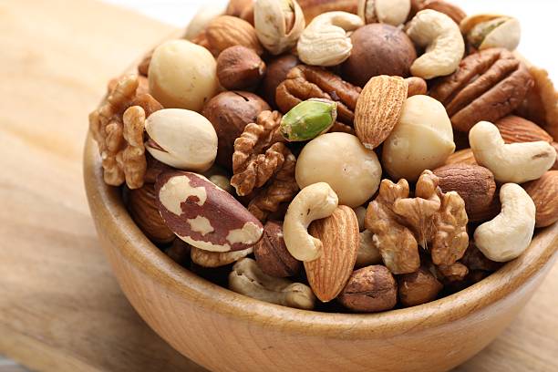 istock Mix of different nuts in bowl on table, closeup 2246659466
