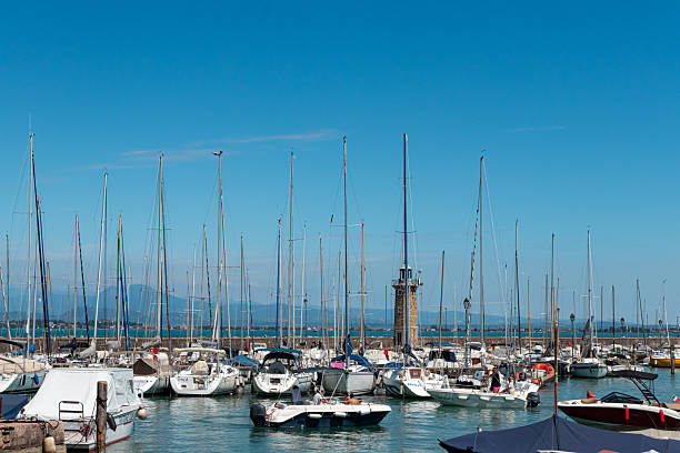 Desenzano del Garda, Italy- August 5, 2025: Desenzano waterfront lighthouse at local harbour port